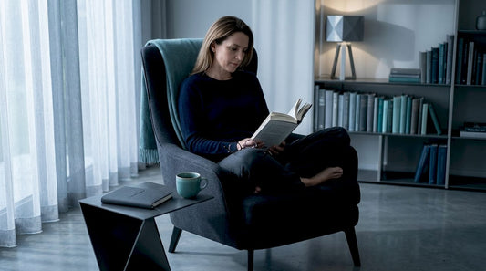 Woman reading book in calm living room