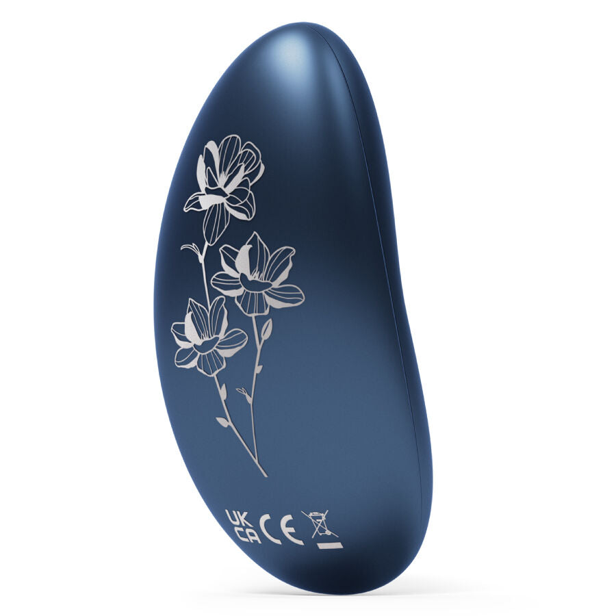Blue ergonomic personal massager with white floral design on smooth matte surface.