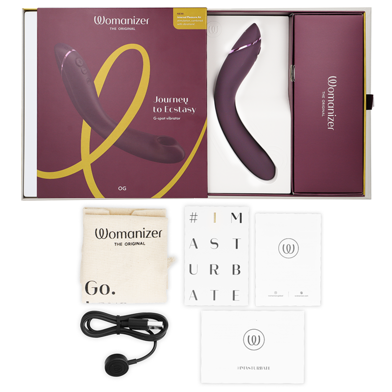 Aubergine-colored curved Womanizer OG G-Spot vibrator with rounded tip, matching box, USB charging cable, storage pouch, and .