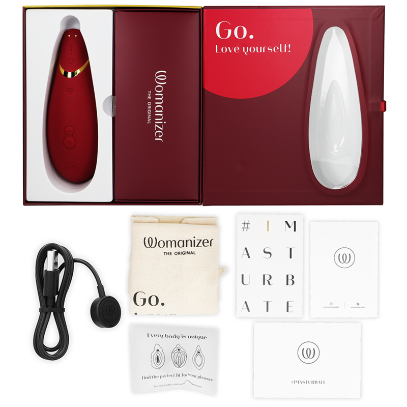 Bordeaux Womanizer Premium 2 clitoral stimulator with USB cable, pouch, and user manuals in open box.