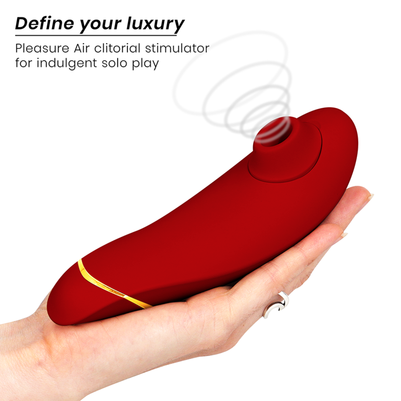 Bordeaux curved clitoral stimulator with gold accent held in hand, sleek matte finish.