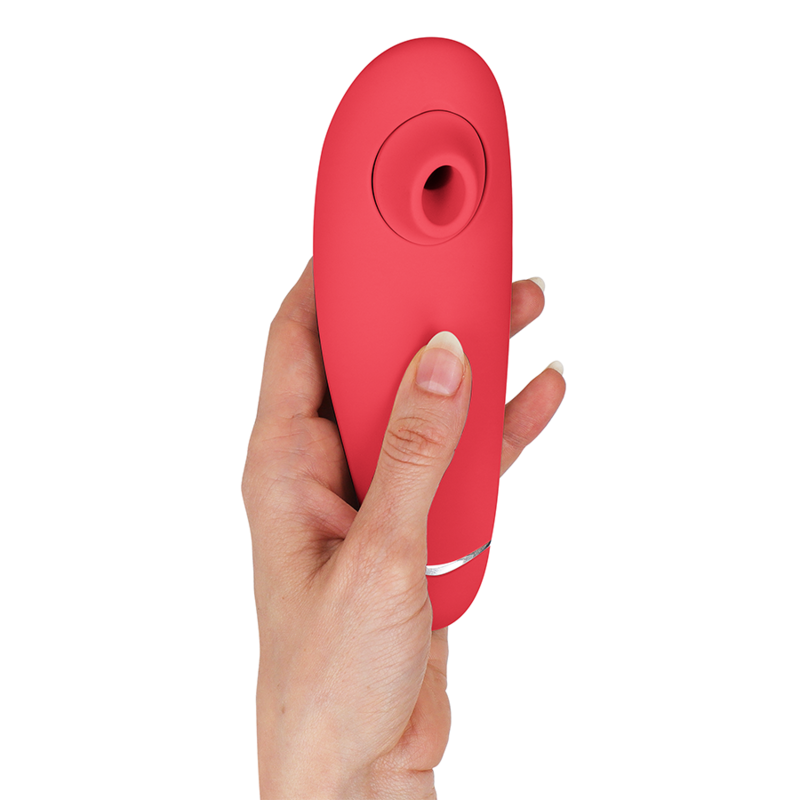 Raspberry red clitoral stimulator with silicone body held in hand, ergonomic curved design.