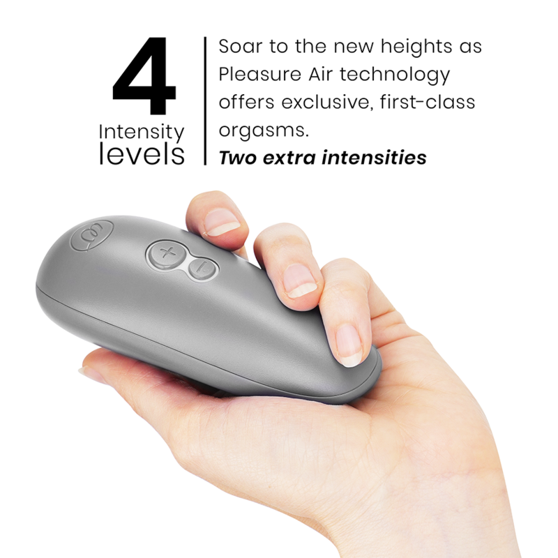Gray ergonomic clitoral stimulator with three buttons, held in hand with thumb on controls.