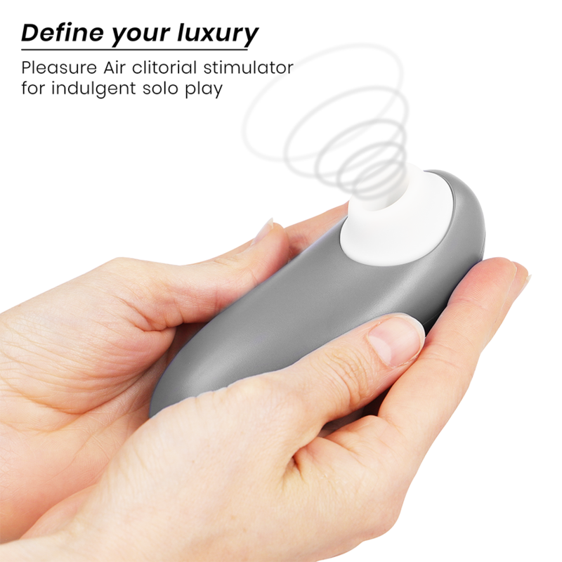 Hand holding gray Womanizer Starlet 3 clitoral stimulator with white nozzle and air pulse waves illustration above it.