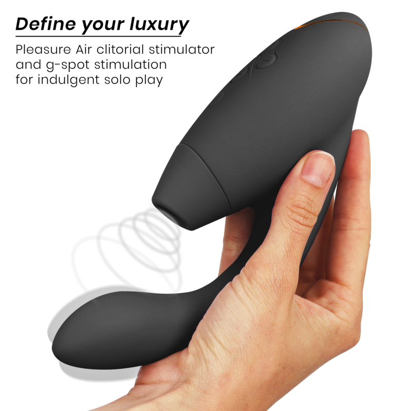 Black dual stimulator with smooth matte finish held in hand, designed for clitoral and G-spot stimulation.