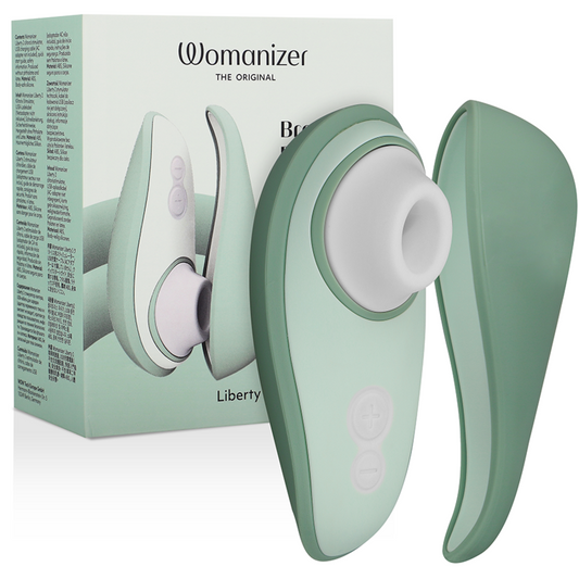 Light green Womanizer Liberty 2 clitoris stimulator with silicone suction head and protective cover.