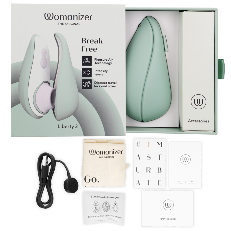 Light green Womanizer Liberty 2 clitoris stimulator with soft silicone tip, carrying case, USB charger, and accessories box.