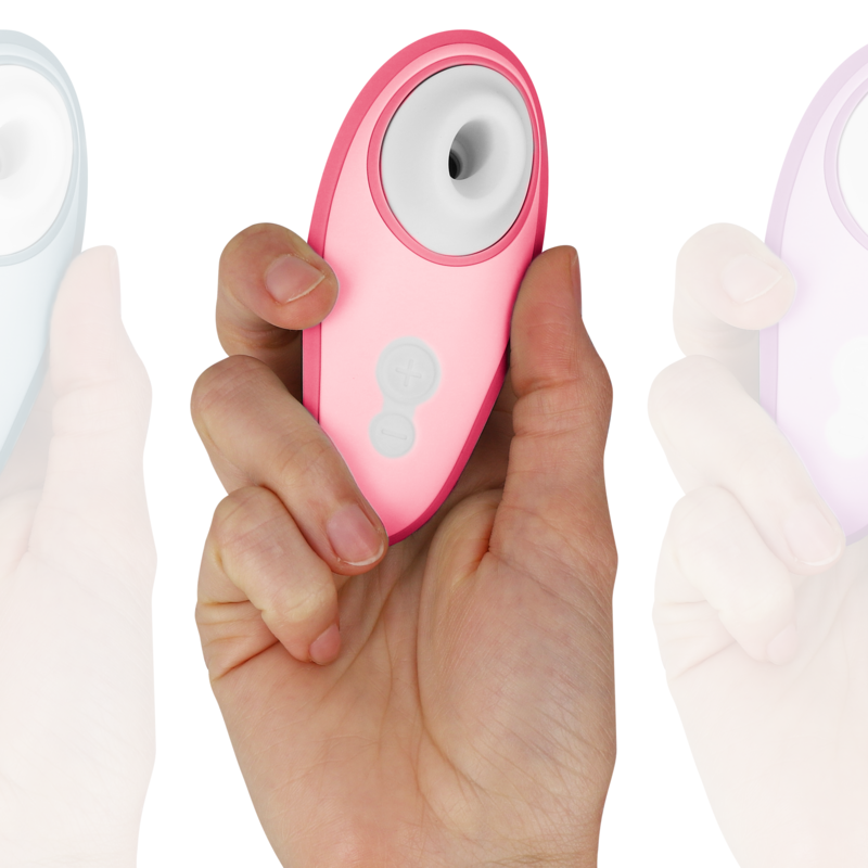 Hand holding a pink Womanizer Liberty 2 clitoris stimulator with suction head and two control buttons.