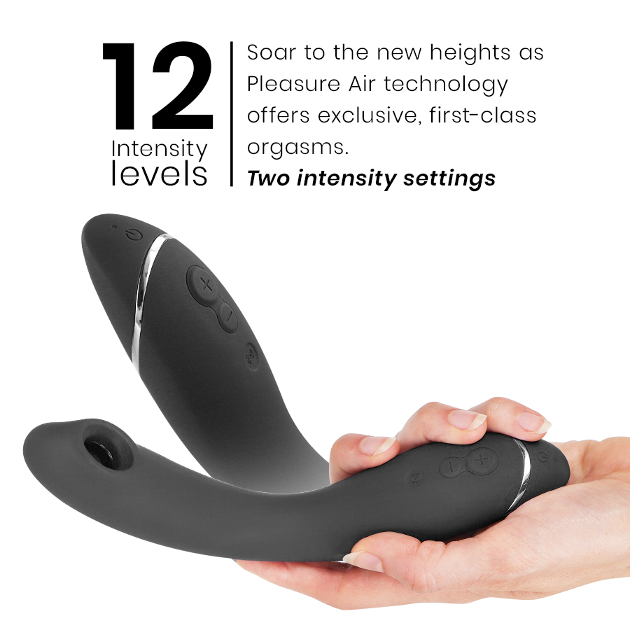 Black silicone Womanizer OG G-Spot vibrator with curved head and control buttons held in hand.