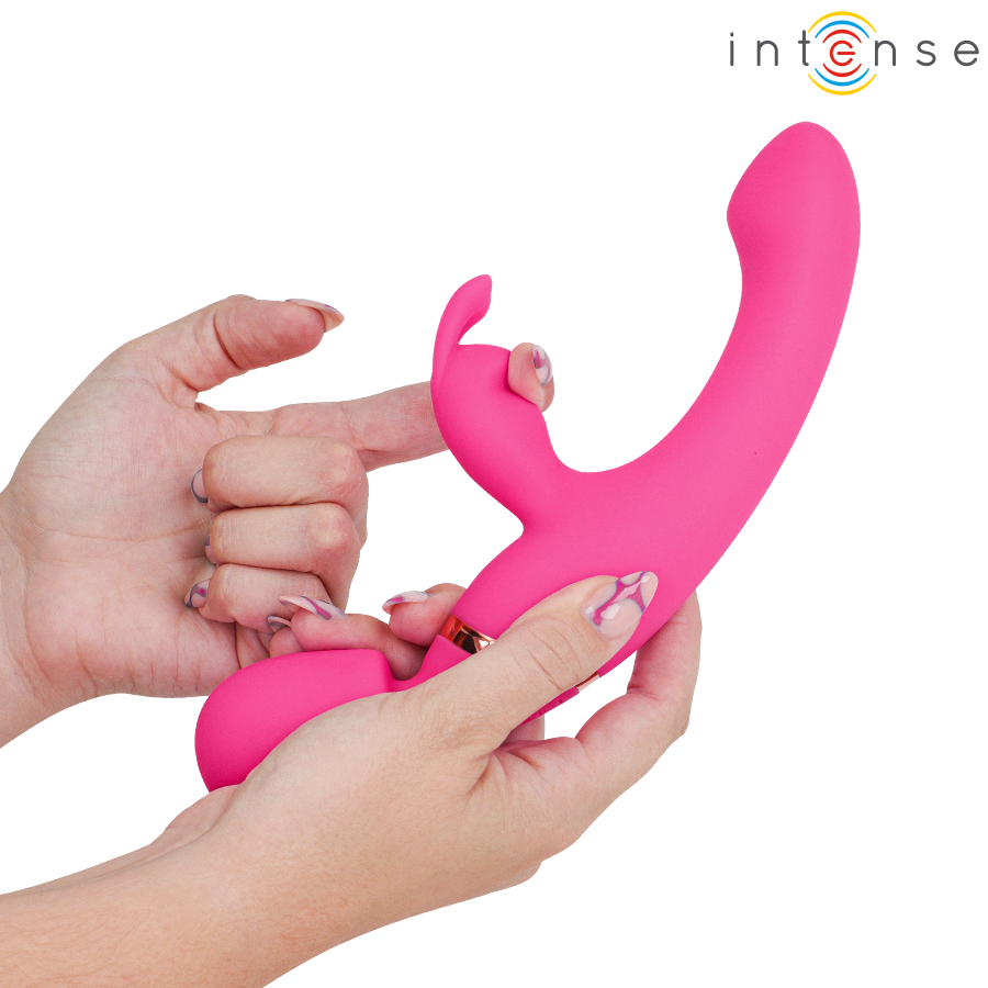 Pink dual-stimulation rabbit vibrator with curved shaft and flexible clitoral arm held in hand.