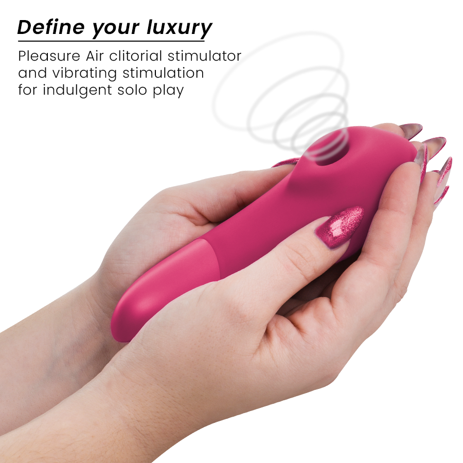 Vibrant pink Womanizer Enhance clitoral stimulator with smooth silicone body held in hands with matching pink nails.