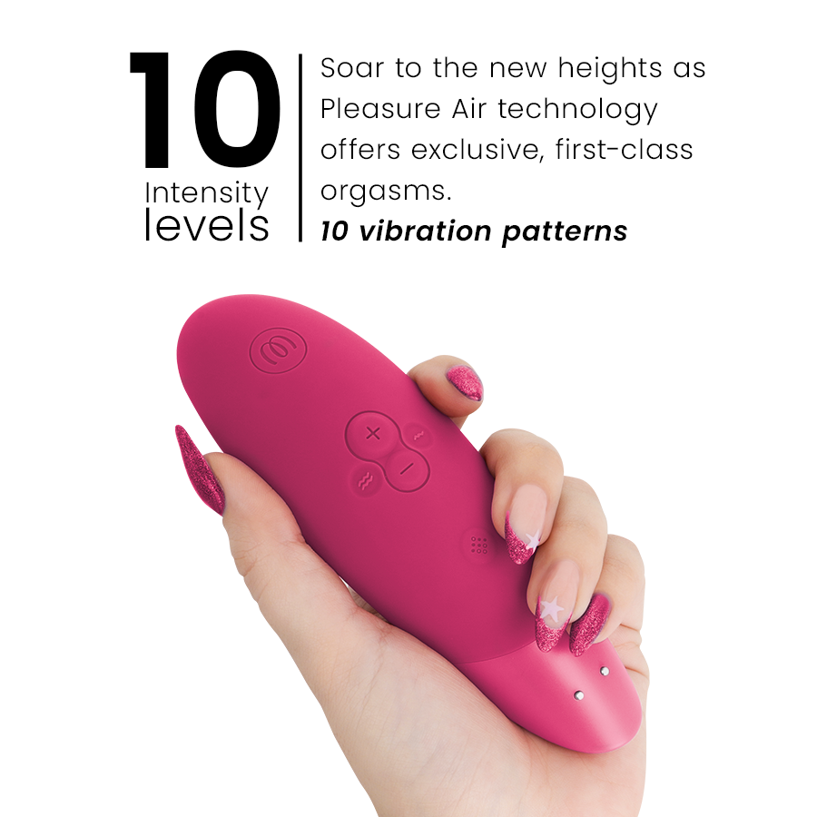 Vibrant pink clitoral stimulator with smooth ergonomic design held in hand with manicured nails.