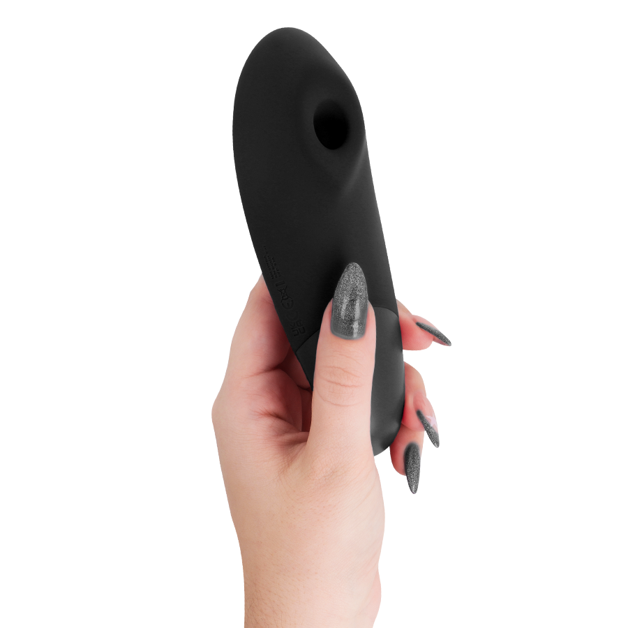 Black sleek clitoral stimulator with ergonomic curved design held in hand.