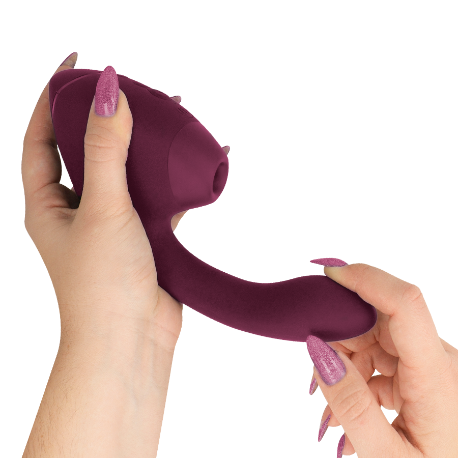 Dusky pink dual stimulator with curved G-spot arm and clitoral suction head held in hands.