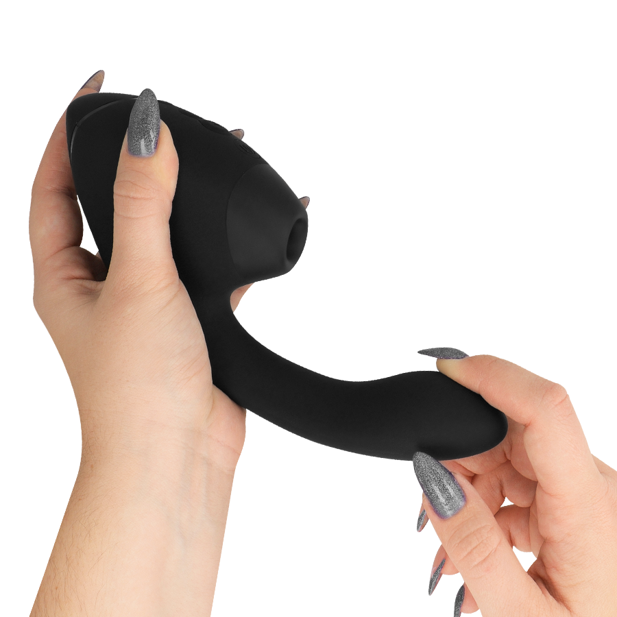 Black dual-ended silicone stimulator with rounded clitoral suction tip and curved G-spot arm held by hands with metallic.