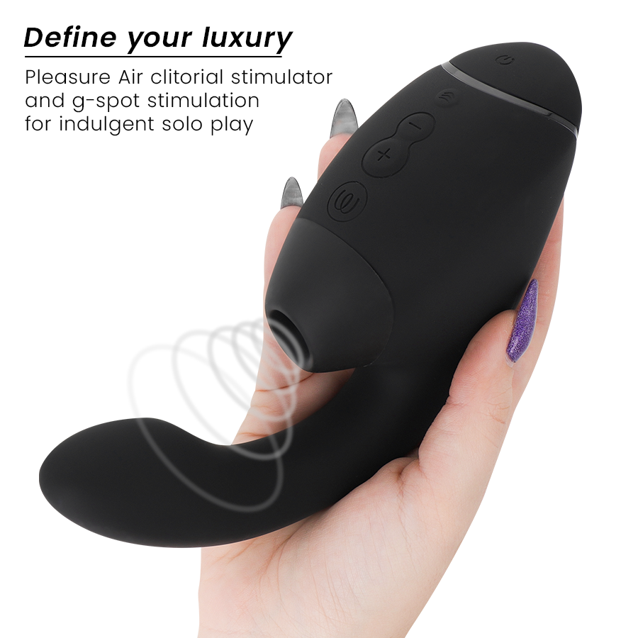 Black dual stimulator with curved tip and ergonomic handle held in hand.