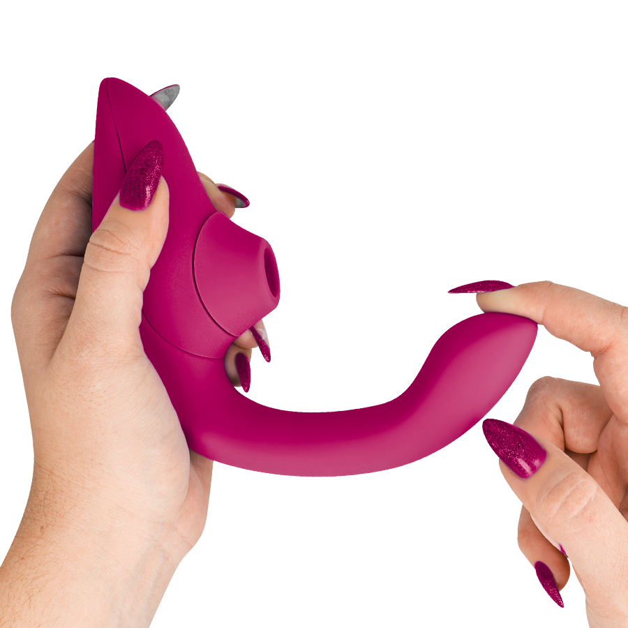 Vibrant pink rabbit vibrator stimulator with curved shaft and clitoral attachment held by hand.