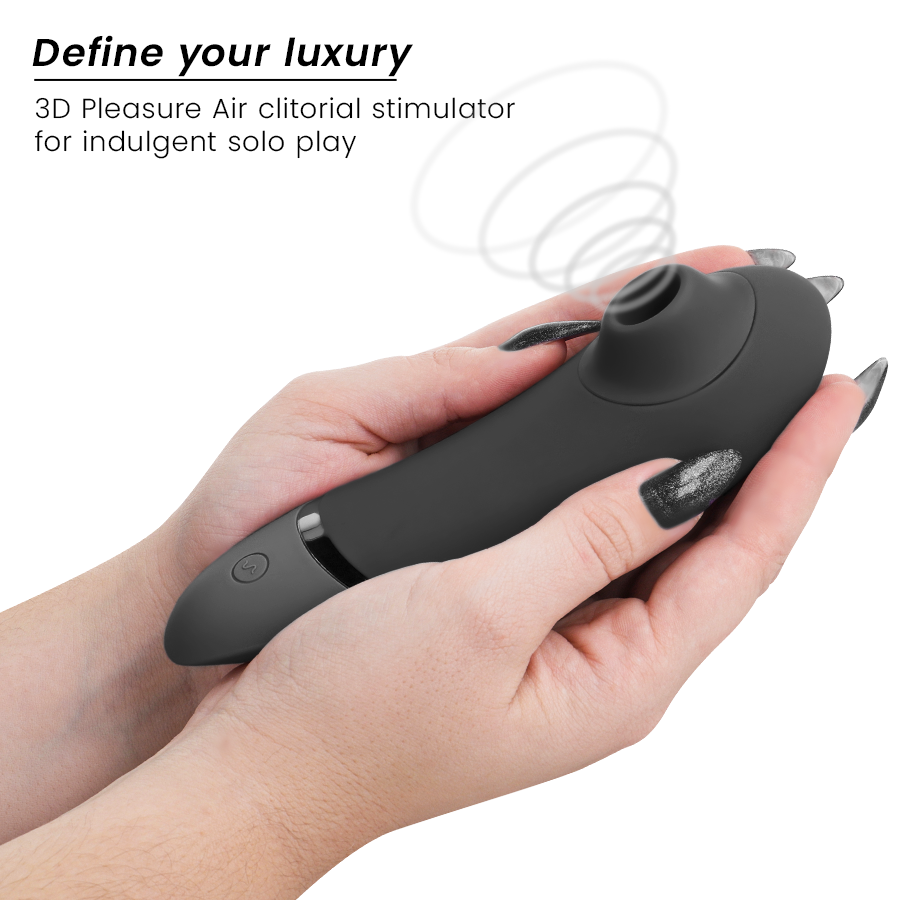 Black ergonomic clitoral stimulator with smooth silicone surface, held in hands with black nail polish.