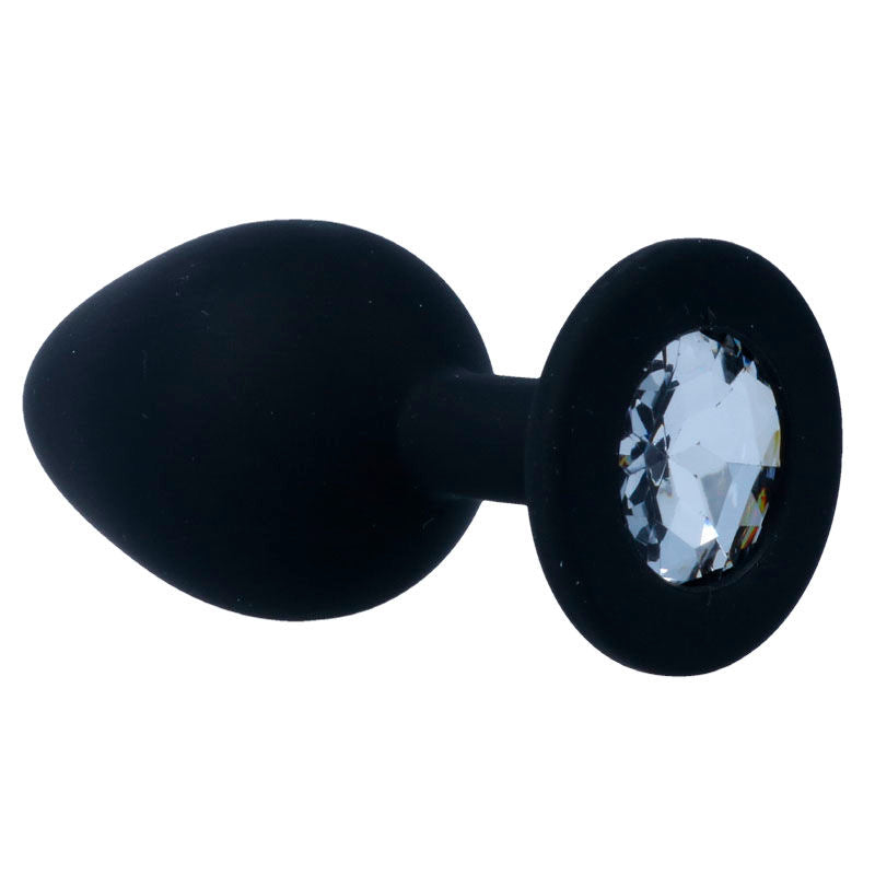 Black silicone anal plug with a tapered shape and a large clear crystal jewel base.
